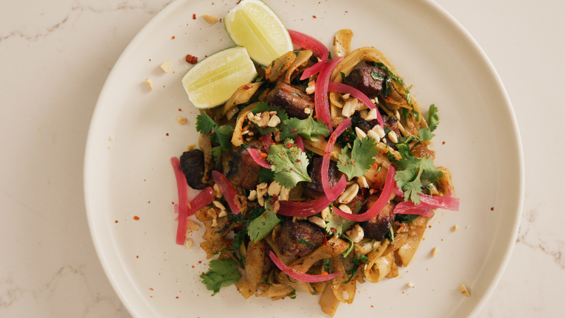 Plated dish of vibrant pad see ew, shot from above